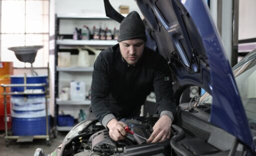 man-in-black-jacket-and-black-knit-cap-standing-near-vehicle-3807329